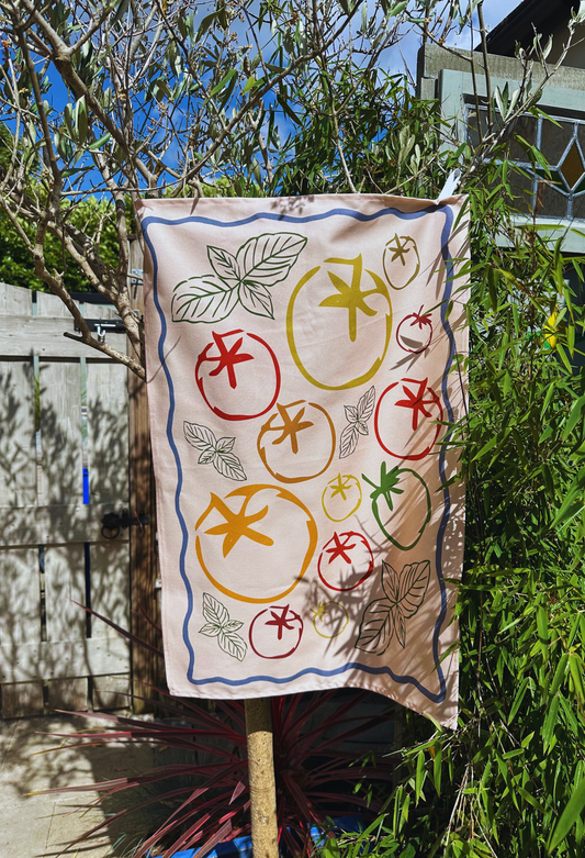 Decorative Casa Olivia Tomato and Basil Tea Towel hanging outdoors