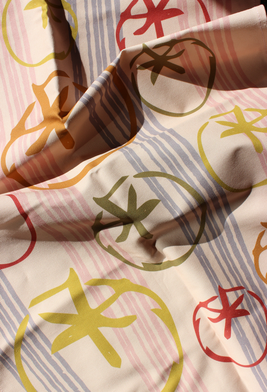 Close-up of tea towel fabric with colorful abstract tomato pattern